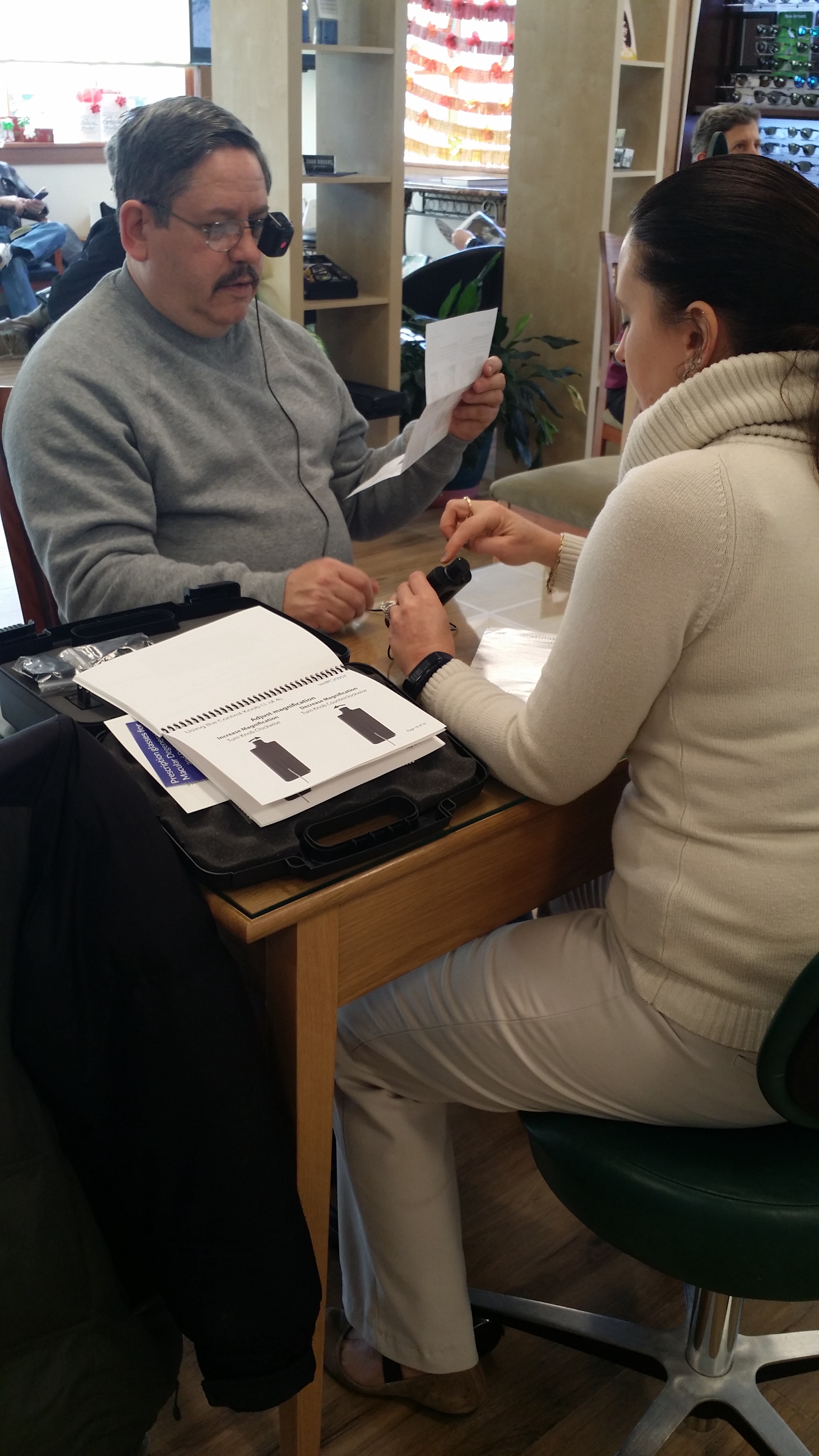 AMDF's Paul Gariepy tests reading with his newly fitted SeeBoost glasses