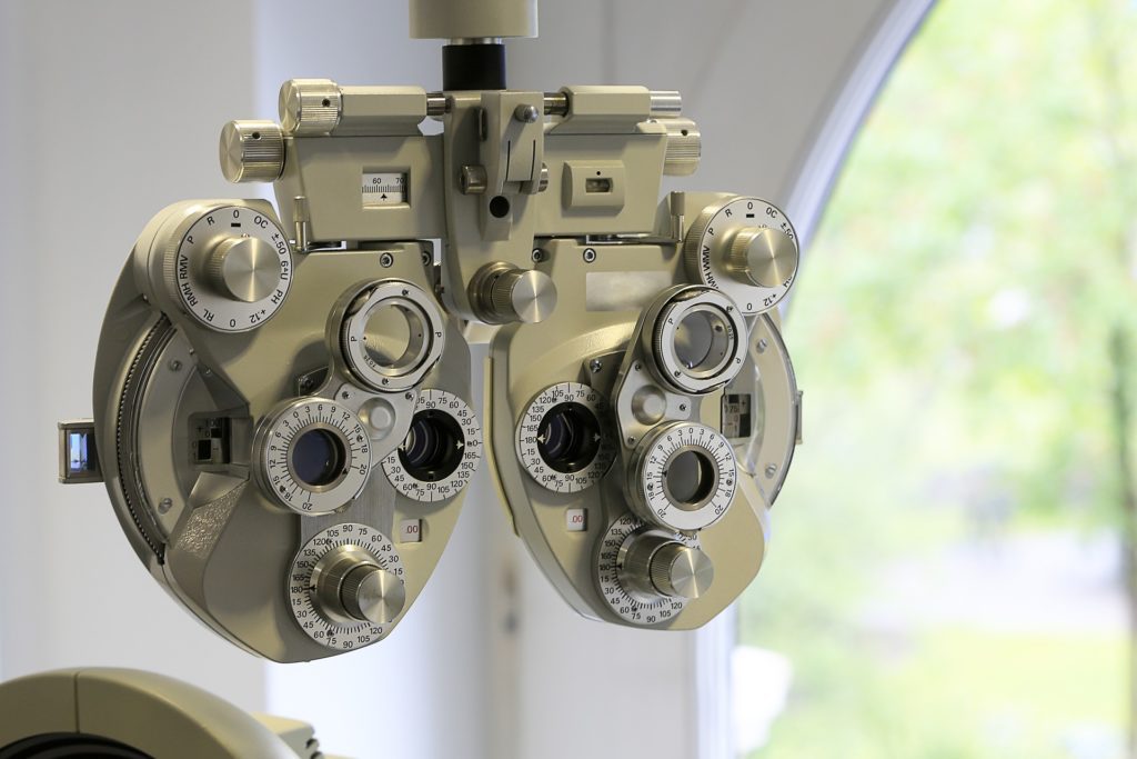 Image of phoropter, a common device with multiple lenses used by eye doctors.