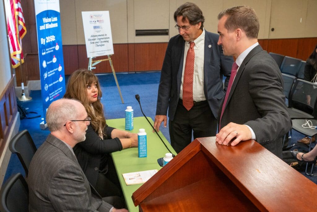 Seated: Mark Roser and Neena Haider, speaking to AMDF Grants Director Matthew Levine, and AAO Congressional Affairs Director Mark Lukaszewski.